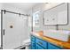 Modern bathroom with blue vanity, vessel sink, and walk-in shower at 1138 Ricochet Dr, Raleigh, NC 27610