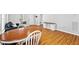 Warm dining area featuring wood floors, an oval wood table, and white chairs next to a living area at 1138 Ricochet Dr, Raleigh, NC 27610