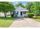 Charming light blue home with a cozy front porch and well-manicured lawn and a concrete driveway at 1138 Ricochet Dr, Raleigh, NC 27610