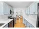 Stylish kitchen with light blue cabinetry, stainless steel appliances, and quartz countertops and wood floors at 1138 Ricochet Dr, Raleigh, NC 27610