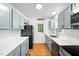 Bright kitchen featuring light blue cabinets, stainless steel appliances, and wood flooring for a modern design at 1138 Ricochet Dr, Raleigh, NC 27610