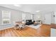 Open-concept living space featuring wood floors, natural light, and comfortable seating and dining area at 1138 Ricochet Dr, Raleigh, NC 27610