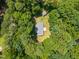Aerial view of property highlighting the house, storage shed, and surrounding lush greenery, offering privacy at 117 Lema Dr, Garner, NC 27529