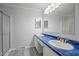 Bright bathroom with a double sink vanity, blue counter top, and neutral-colored walls at 117 Lema Dr, Garner, NC 27529