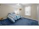 Cozy bedroom with blue carpet, a queen-sized bed, and a window with natural light at 117 Lema Dr, Garner, NC 27529