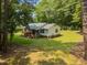 A charming home nestled among mature trees, offering a peaceful and private setting with a large front yard at 117 Lema Dr, Garner, NC 27529