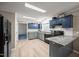 Open kitchen with granite countertops, gray cabinets, and stainless steel appliances at 117 Lema Dr, Garner, NC 27529