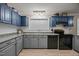 Charming kitchen boasts custom cabinets, black appliances, and modern countertops at 117 Lema Dr, Garner, NC 27529