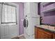 Practical laundry room with stacked washer/dryer, storage, and utility sink at 117 Lema Dr, Garner, NC 27529