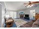 Comfortable living room with brick fireplace, plush seating, ceiling fan, and cozy ambiance at 117 Lema Dr, Garner, NC 27529
