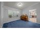 Cozy living room featuring a piano with abundant natural light and connection to the kitchen at 117 Lema Dr, Garner, NC 27529