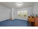 Spacious living room with a piano, large window, and cozy blue carpeting at 117 Lema Dr, Garner, NC 27529