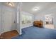 Cozy living room with natural light, blue carpet, and a classic piano, creating a warm atmosphere at 117 Lema Dr, Garner, NC 27529