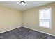 A well-lit bedroom with neutral walls and carpet at 117 Renee Dr, Smithfield, NC 27577
