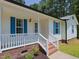 Charming front porch with brick steps, white railings, and blue shutter accents at 117 Renee Dr, Smithfield, NC 27577