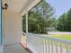 View from the porch of a charming home surrounded by lush greenery and a quiet neighborhood street at 117 Renee Dr, Smithfield, NC 27577