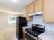 View of kitchen oven, range, and view to dining room with large window at 117 Renee Dr, Smithfield, NC 27577