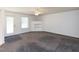Bright living room with carpet, ceiling fan, and built-in shelving at 117 Renee Dr, Smithfield, NC 27577