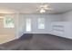 Open-concept living room with ceiling fan, carpet flooring and a view of the dining area at 117 Renee Dr, Smithfield, NC 27577