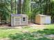 This view shows two backyard storage sheds with neutral paint schemes at 117 Renee Dr, Smithfield, NC 27577
