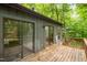 Exterior view of home featuring a wood deck with sliding glass doors and steps to the backyard at 120 Polks Landing Rd, Chapel Hill, NC 27516