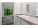 Bathroom featuring a vanity with tiled countertop and a sink, offering natural light at 120 Polks Landing Rd, Chapel Hill, NC 27516