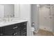 Modern bathroom featuring dark vanity, sink, toilet, and glass-enclosed walk-in shower at 120 Polks Landing Rd, Chapel Hill, NC 27516