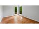 Bright room with hardwood floors and large windows overlooking a lush landscape at 120 Polks Landing Rd, Chapel Hill, NC 27516