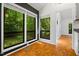 Sunlit dining area with parquet floors and large windows overlooking lush greenery at 120 Polks Landing Rd, Chapel Hill, NC 27516