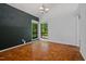 Bright dining room with parquet floors, two large windows, and dark accent wall at 120 Polks Landing Rd, Chapel Hill, NC 27516