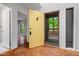 Bright foyer with a striking yellow door and wood floors, welcoming you into the home's interior at 120 Polks Landing Rd, Chapel Hill, NC 27516