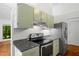 Kitchen featuring modern appliances, gray countertops and updated cabinets at 120 Polks Landing Rd, Chapel Hill, NC 27516