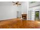 Spacious living room with fireplace, parquet floors, and a ceiling fan at 120 Polks Landing Rd, Chapel Hill, NC 27516