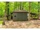 View of storage shed in backyard, featuring a natural setting at 120 Polks Landing Rd, Chapel Hill, NC 27516