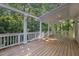 Enjoy this spacious wooden back deck with white railings, overlooking the lush yard and forest at 122 N Fern Abbey Ln, Cary, NC 27518