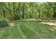 This beautifully landscaped lawn features mature trees and provides ample space to relax and play at 122 N Fern Abbey Ln, Cary, NC 27518