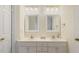 Bathroom with a double sink vanity, neutral color palette, and well-lit mirrors at 122 N Fern Abbey Ln, Cary, NC 27518