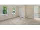 Bedroom featuring carpeting, two large windows and a closet at 122 N Fern Abbey Ln, Cary, NC 27518