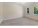 Light-filled bedroom featuring plush carpeting and plenty of natural light at 122 N Fern Abbey Ln, Cary, NC 27518