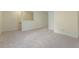 Large bonus room features neutral carpeting, light colored walls, and stairs to the second floor at 122 N Fern Abbey Ln, Cary, NC 27518