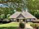 The Lochmere Recreation Club clubhouse is surrounded by mature trees and meticulously maintained landscaping at 122 N Fern Abbey Ln, Cary, NC 27518