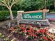 Landscaped community entrance sign for Lochmere Highlands with vibrant flowers at 122 N Fern Abbey Ln, Cary, NC 27518