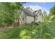 This large, landscaped backyard features a fence and wooden gate that provides access to the rest of the property at 122 N Fern Abbey Ln, Cary, NC 27518