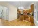 Traditional kitchen with wood cabinets, black countertops, stainless steel refrigerator, and hardwood floors at 122 N Fern Abbey Ln, Cary, NC 27518