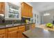 Kitchen features stainless steel sink, wood cabinets, tile backsplash, and stainless steel dishwasher at 122 N Fern Abbey Ln, Cary, NC 27518