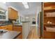 Kitchen featuring wood cabinets, stainless steel refrigerator, and an open view to the living room at 122 N Fern Abbey Ln, Cary, NC 27518