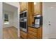 Kitchen area featuring stainless steel built in oven and microwave and light wood cabinets at 122 N Fern Abbey Ln, Cary, NC 27518