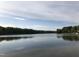 Lake view with treeline and water reflection at 122 N Fern Abbey Ln, Cary, NC 27518