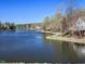 Scenic lake view with shoreline path and houses at 122 N Fern Abbey Ln, Cary, NC 27518