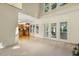 Bright living room featuring soaring ceilings, large windows, and access to a deck at 122 N Fern Abbey Ln, Cary, NC 27518